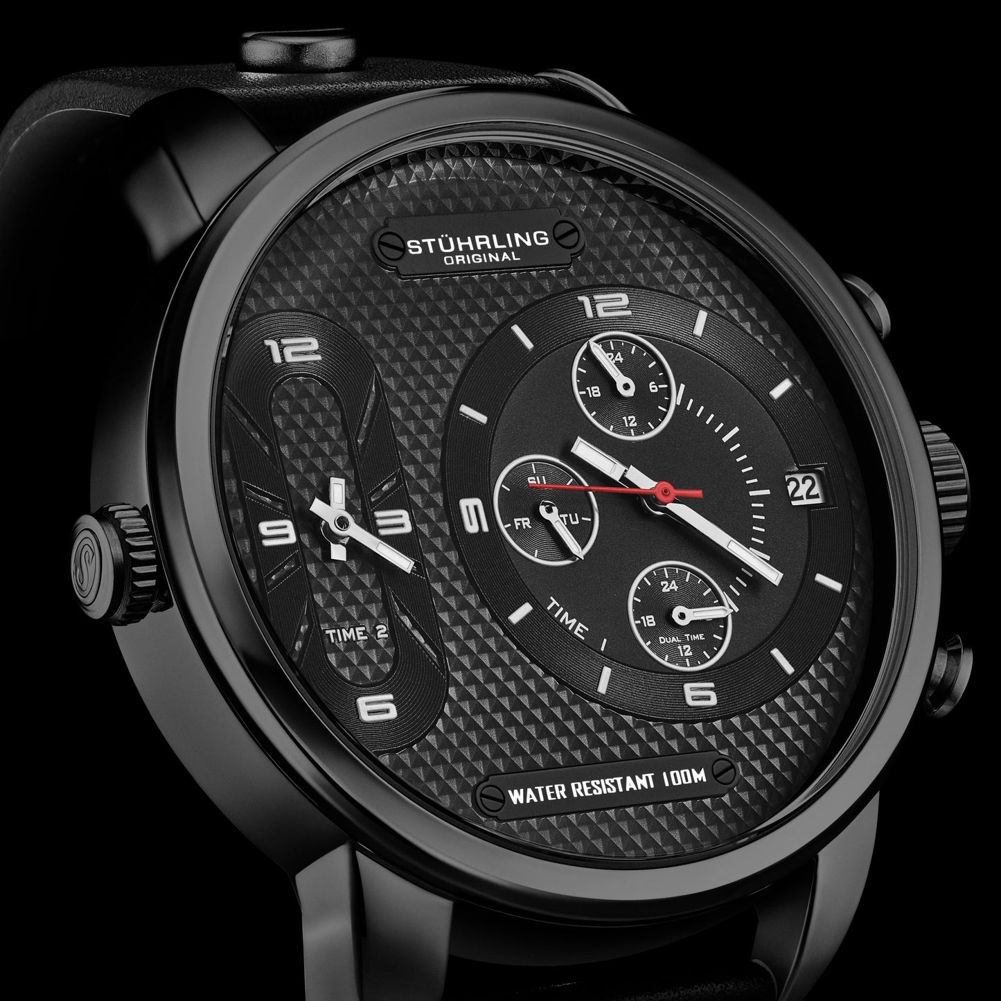 Black Stuhrling watch with detailed face on a black background
