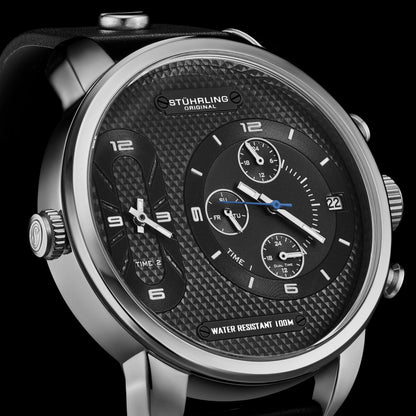 Stuhrling watch with black face and silver case on a black background