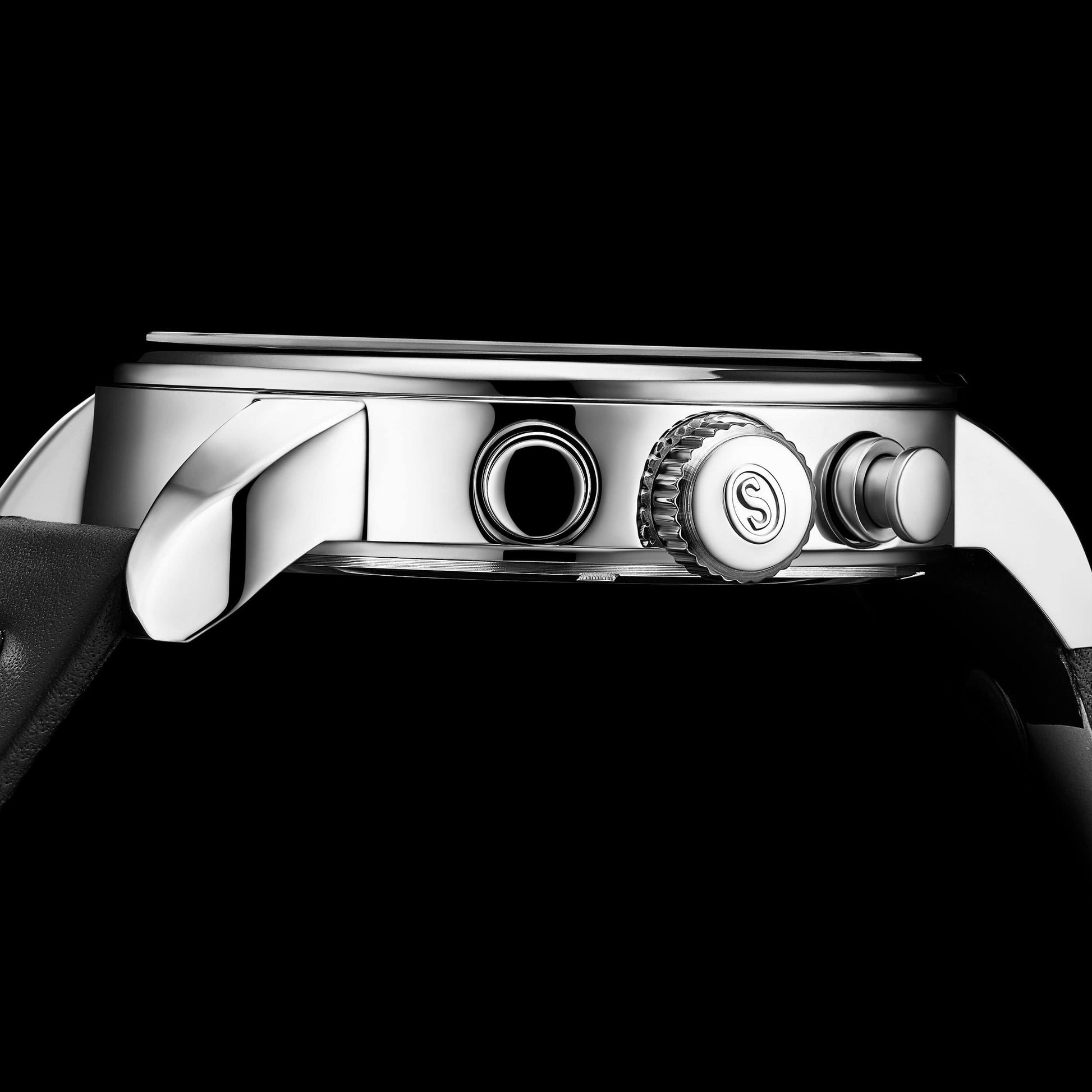 Close-up of a silver watch case with brand logo on a black background