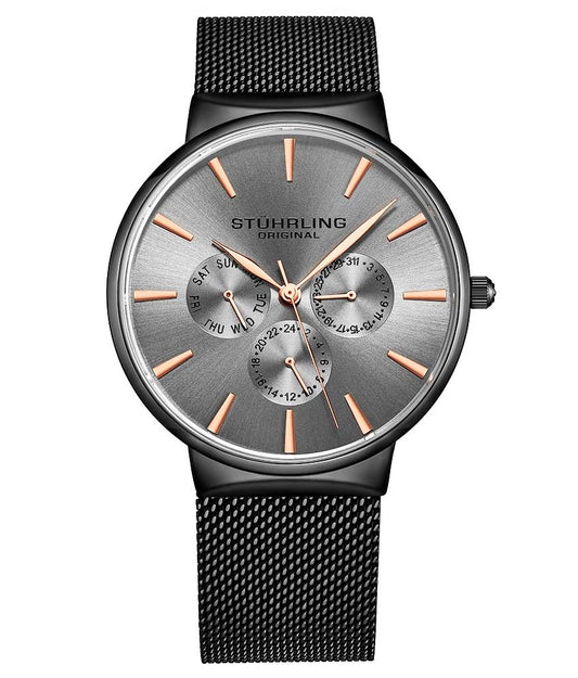 A Stühling brand watch with a silver dial, rose gold hands and markers, and a black mesh bracelet.